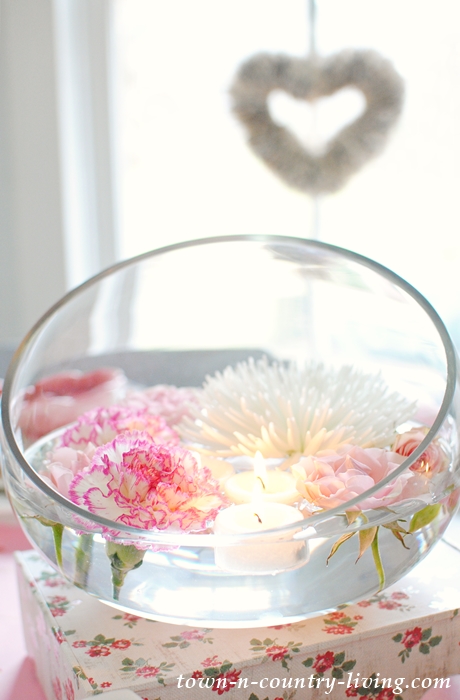 Easiest Flower Arrangement Ever! Simply snip flowers from their stems and let them float in a glass bowl of water.