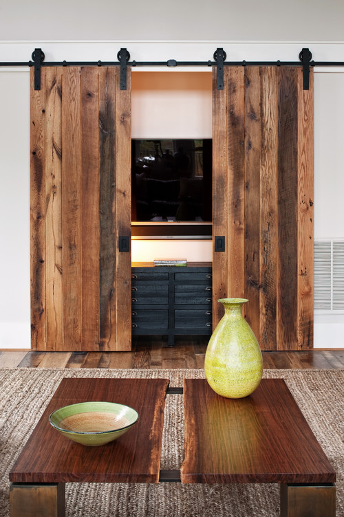 Barn doors slide to conceal a TV screen and electronics