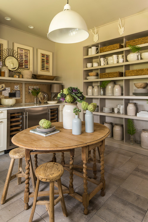 Creamy white stoneware crocks and pottery displayed on shelves