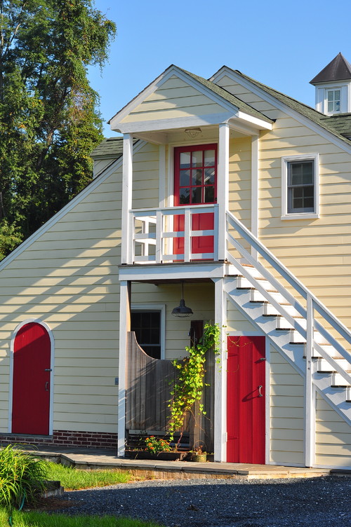 Yellow Two-Story House with Three Red Exterior Doors