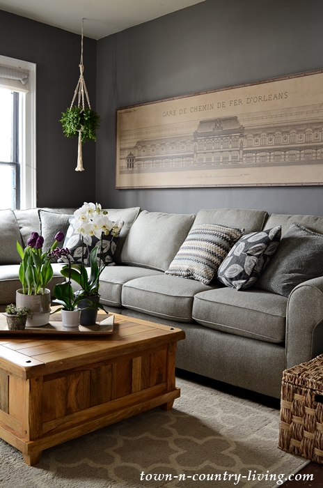 Neutral Sectional Sofa in Family Room with Architectural Paris Train Station Print