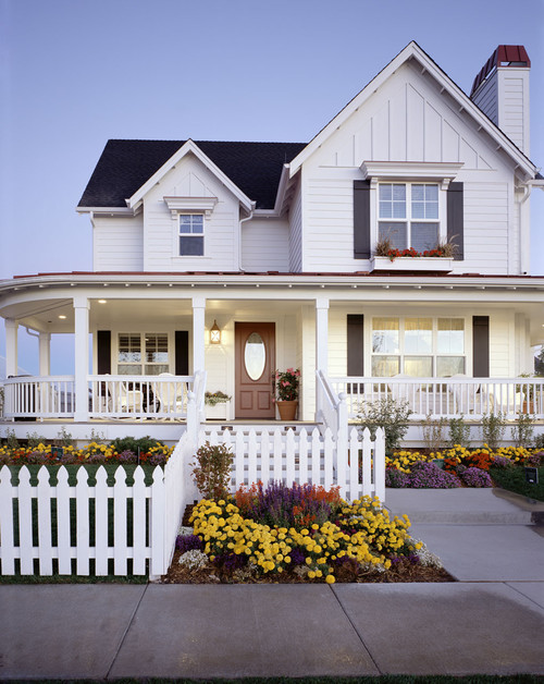 White Picket Fence in the Front Yard with Flower Beds