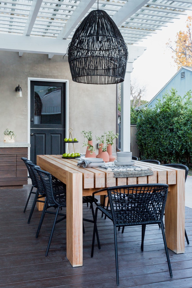 cozy backyard deck with wood dining table