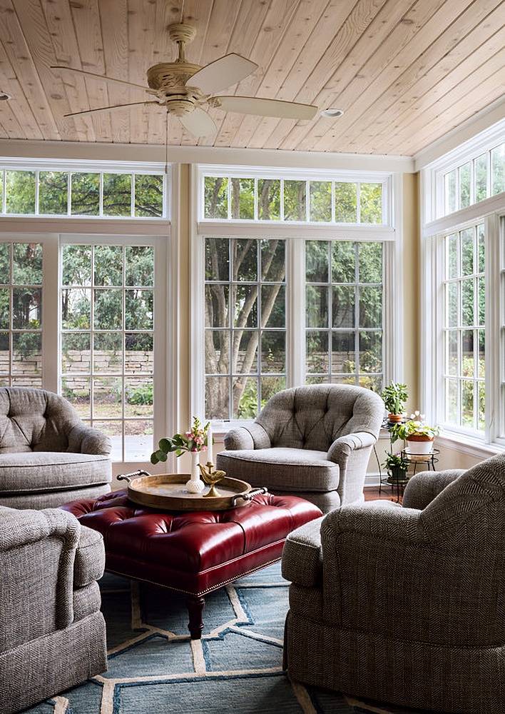 traditional sun room with tufted chairs