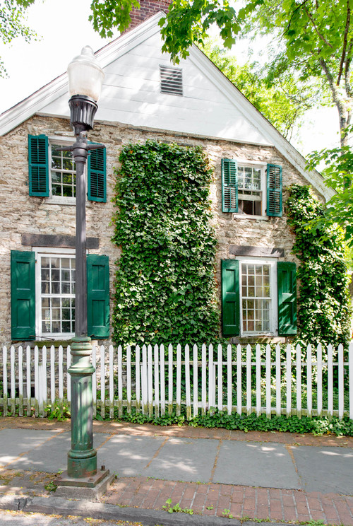 Gorgeous Old Stone House with Turquoise Shutters and White Picket Fence