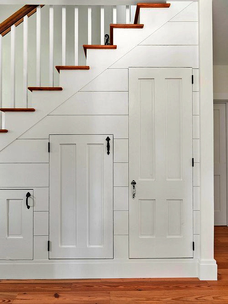 trio of doors under stairway