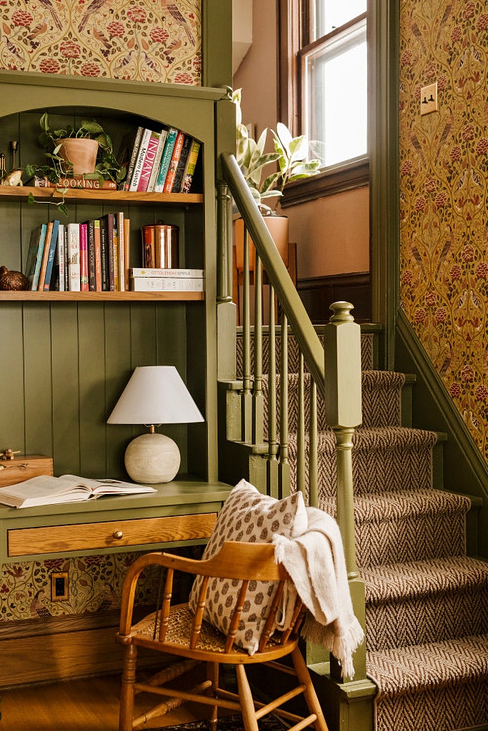 historic home staircase with wallpaper and olive green paint