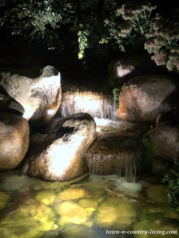 Backyard Pond and Waterfall Lit Up at Night