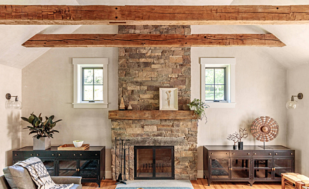 Rustic Family Room with Beamed Ceiling and Stone Fireplace