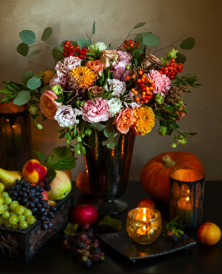 Autumn still life with flowers, pumpkin, fruits and candles