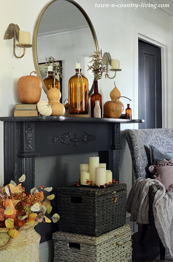 Fall Mantel with Amber Bottles and Dried Gourds