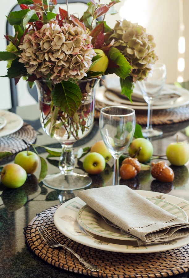Fall table setting with apples and autumn flowers