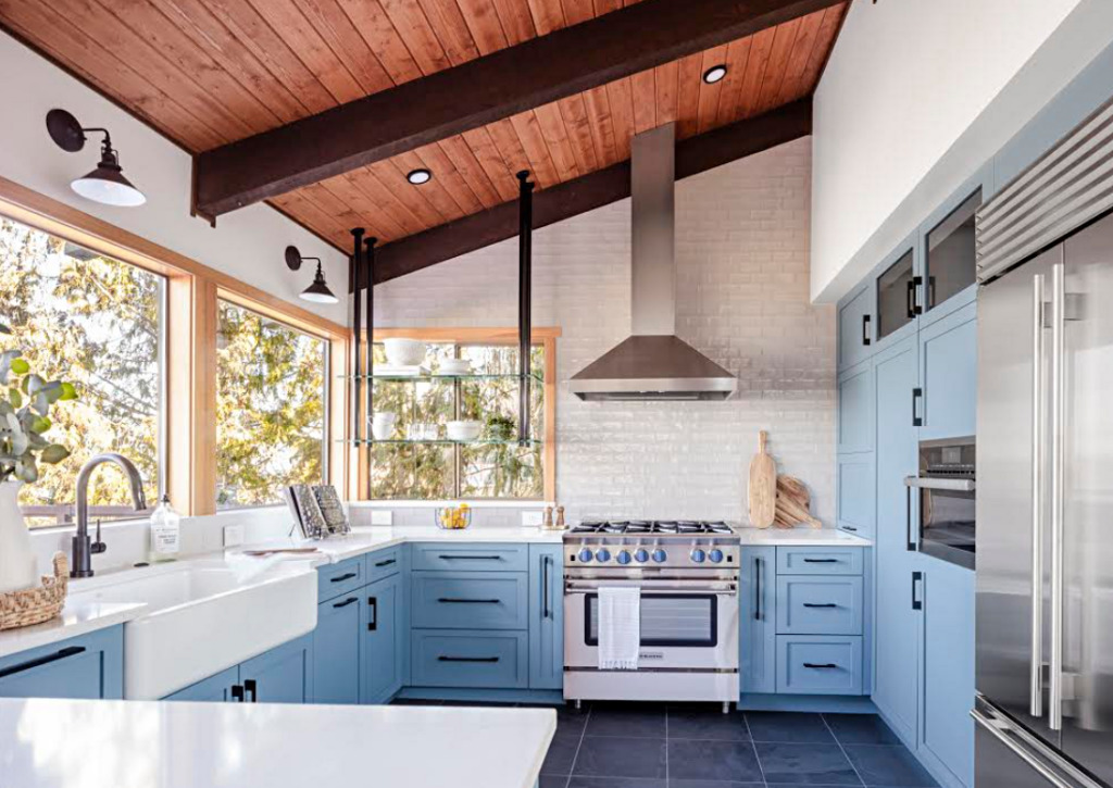 Peaceful blue kitchen with shaker cabinets and vaulted wood ceiling