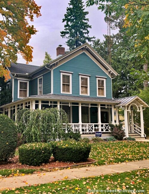 Turquoise Colored Historic Clapboard Home with Wrap Around Porch