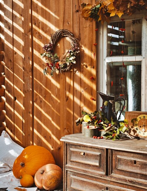 Wooden dresser on a front porch for fall decorating