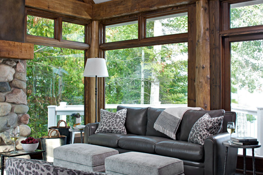 Cabin style living room with expansive windows framed with logs
