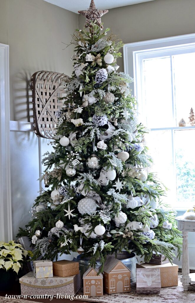 White Ornaments and Ribbons on a Green Christmas Tree