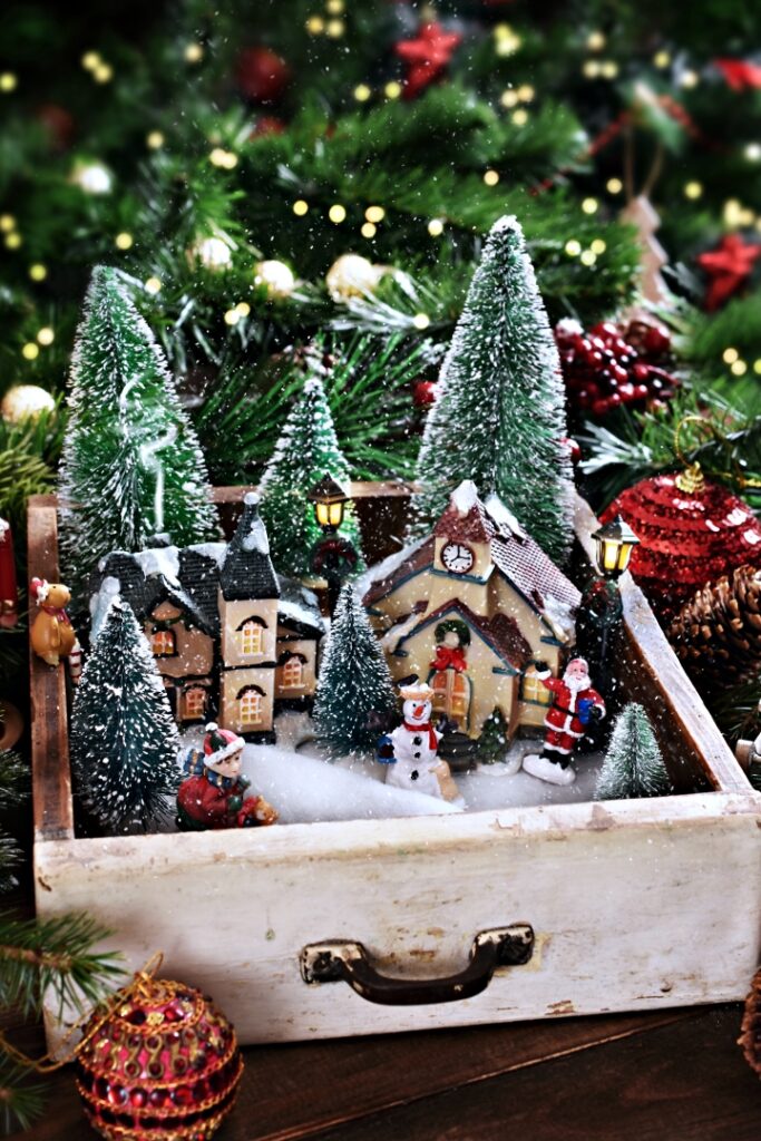 vintage drawer with a winter Christmas scene of a little town with falling snow inside