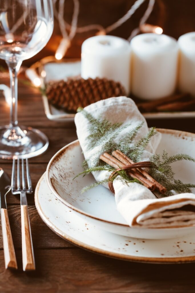 Thanksgiving table setting with linen napkins and cinnamon sticks