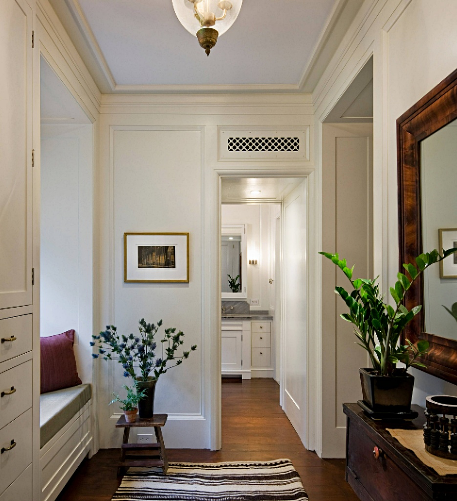 hallway with crown molding and door trim