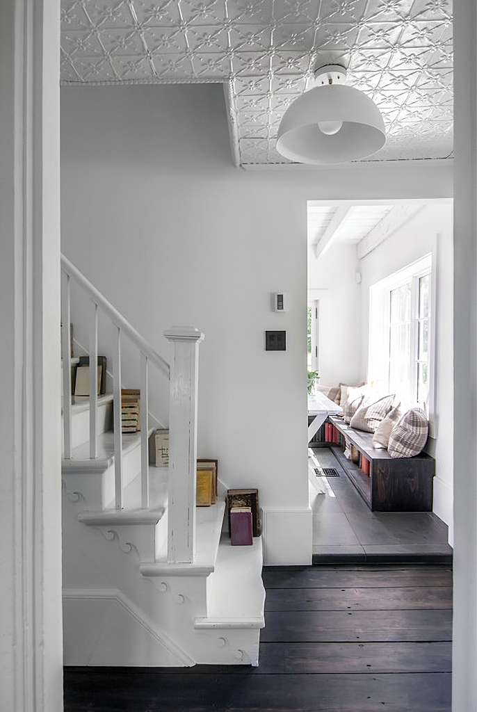 White Scandinavian entryway with stairway
