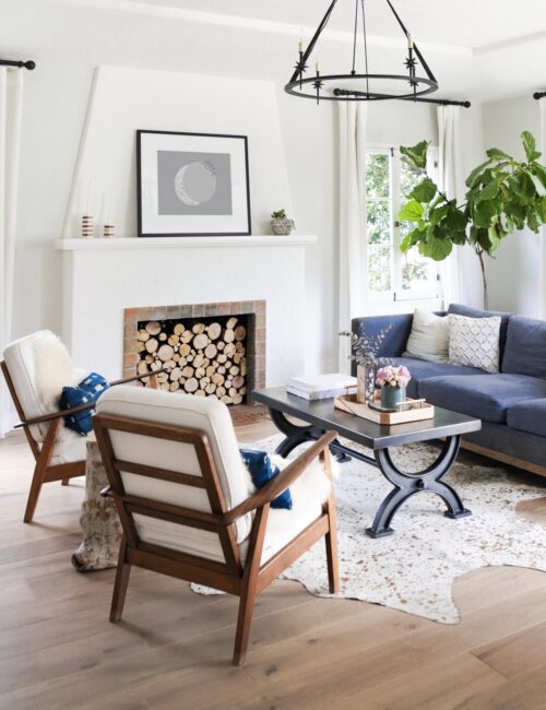 Minimalist living room with white fireplace and fiddle leaf fig