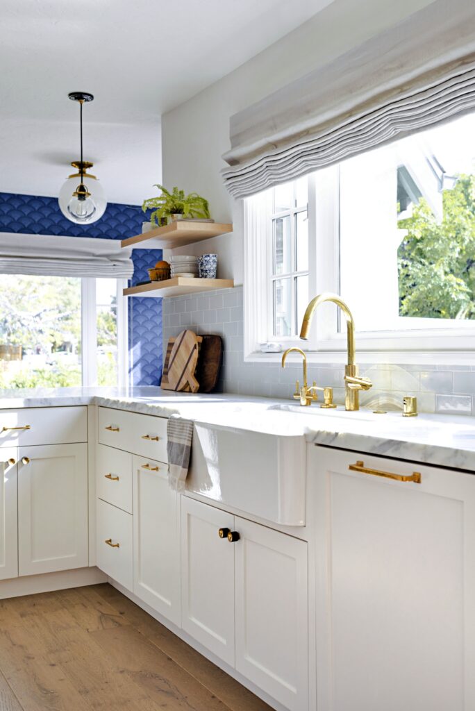 Beach Style Kitchen with White Cabinets and Blue Wallpaper