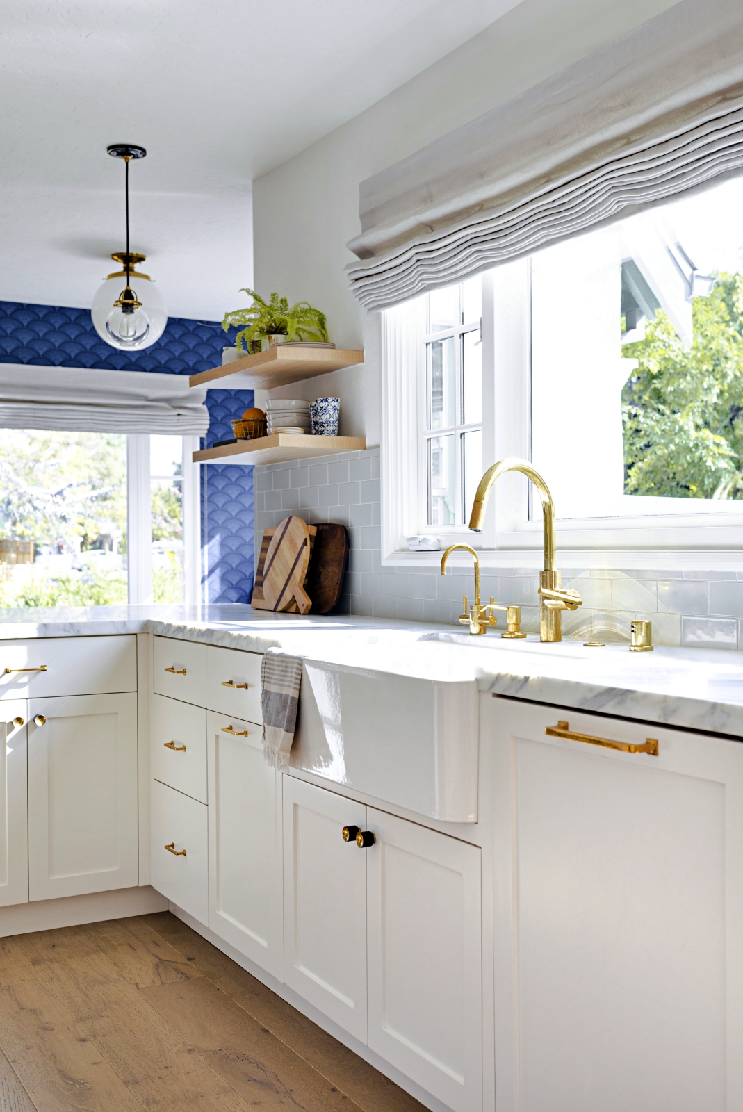 Stunning White Beach Style Kitchen with Patterned Blue Wallpaper