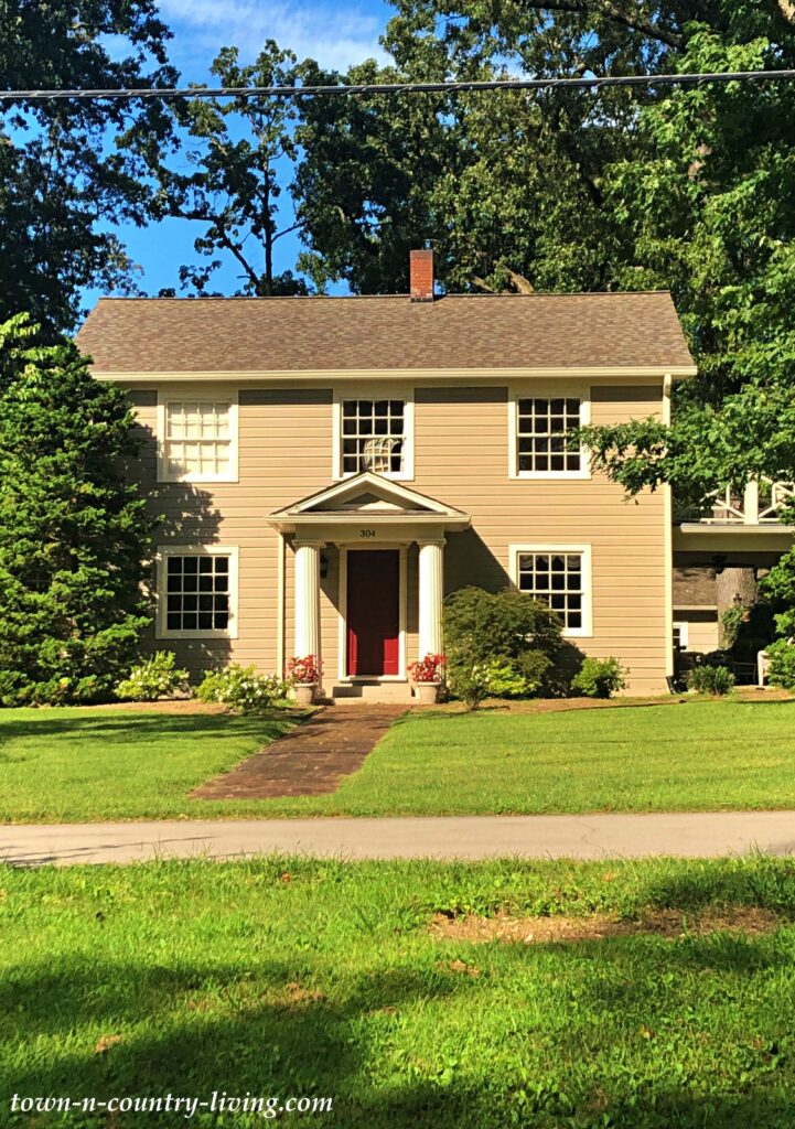 Tan Colonial House with Red Front Door