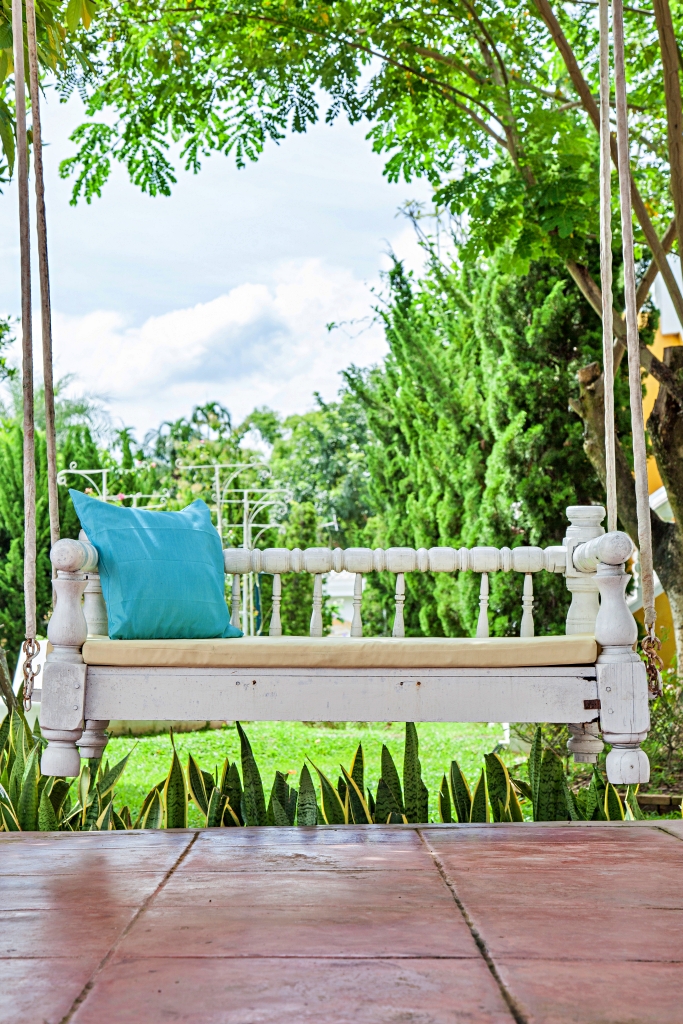 vintage swing and Turquoise blue green pillow in the park