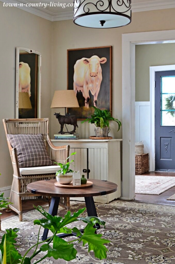 Large cow painting in a country style sitting room