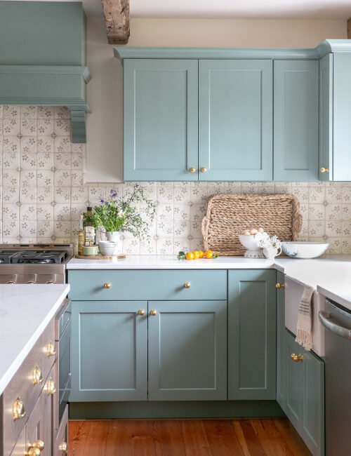 Pale blue kitchen cabinets in English style decor