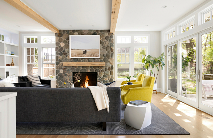 Navy and yellow family room with rustic stone fireplace