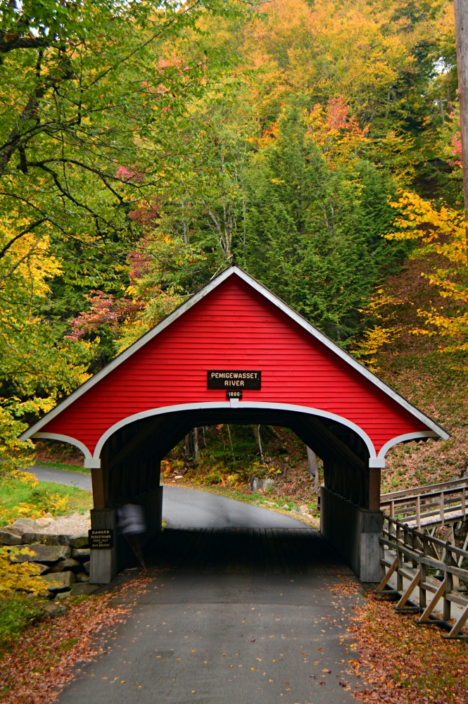 A quaint covered bridge crosses over the Pemigewasset River at Franconia State Park, New Hampshire