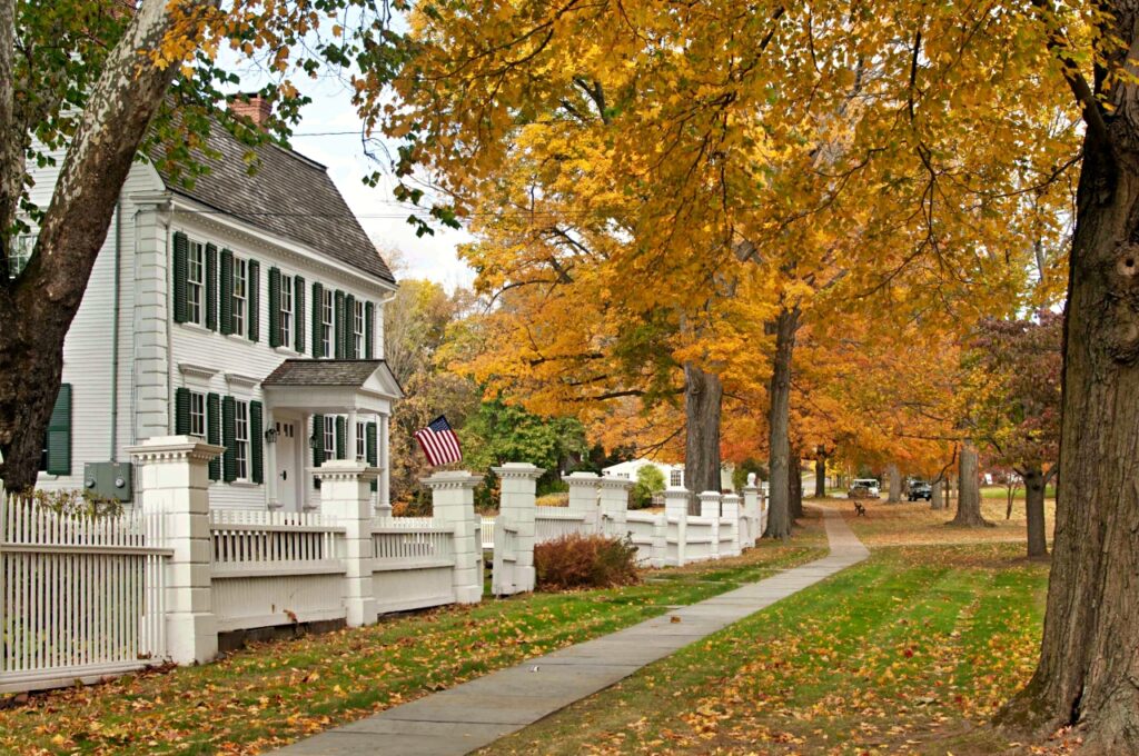 Autumn in New England - classic white house with white fence