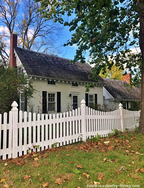 Historic white home with picket fence in Grand Detour, Illinois