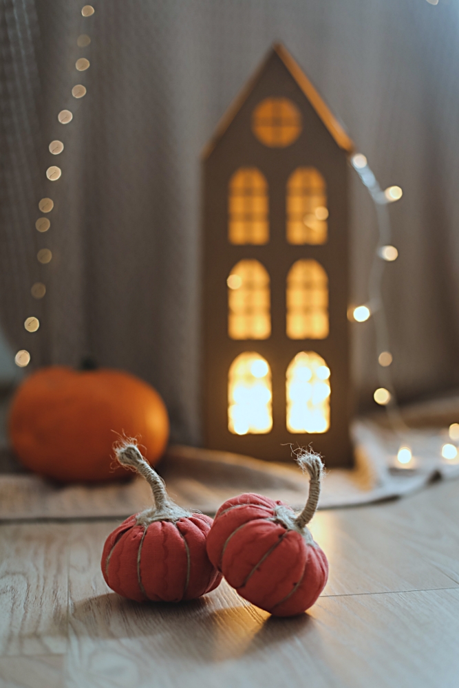 Fall vignette with fabric pumpkins and lighted house