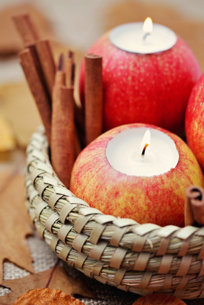 Apple tea light candles with cinnamon sticks in basket