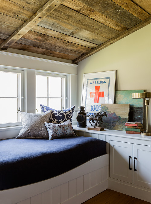 Guest room with pitched wood ceiling and built-in bed