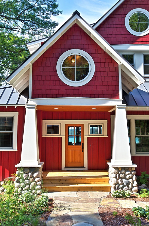 Red modern farmhouse with round windows