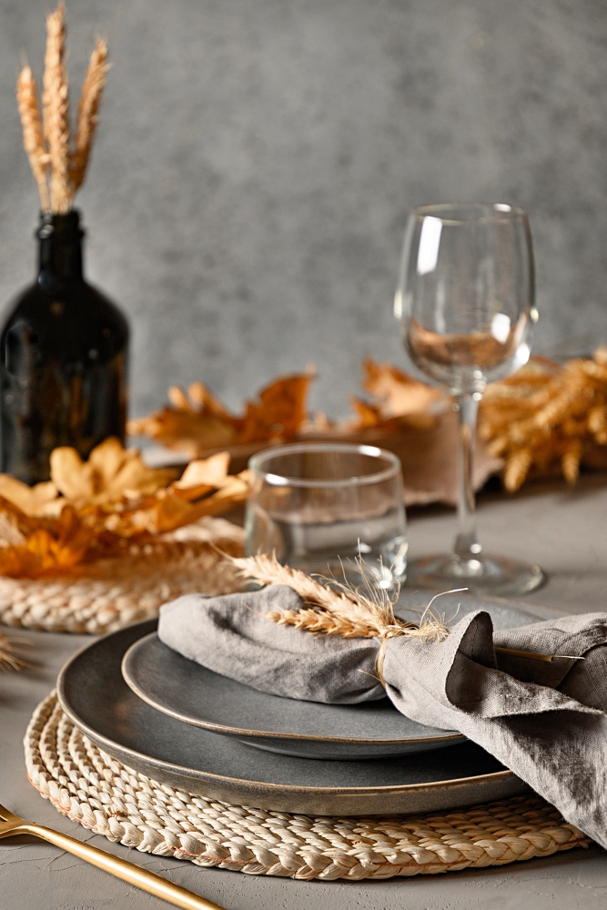 Autumn table setting with dry yellow oak leaves