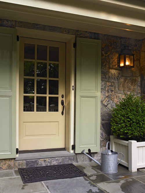 Creamy front door with sage green door shutters