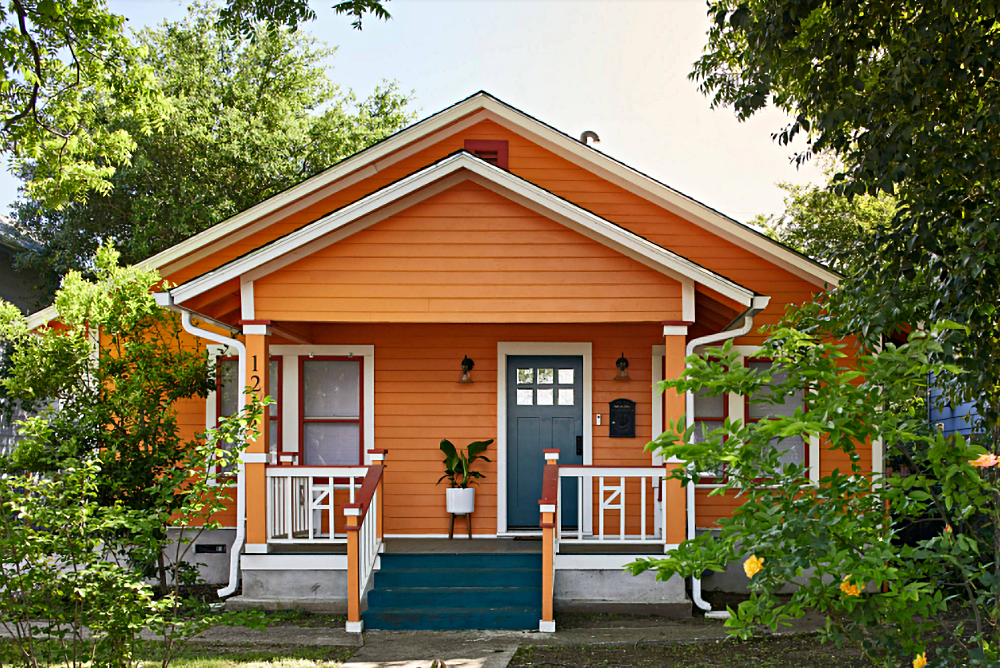 Orange Bungalow Home with Dark Blue Front Door