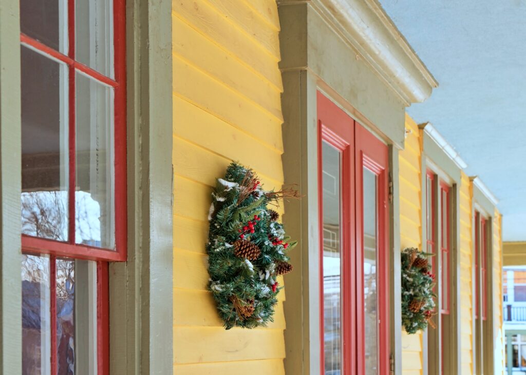 Christmas wreaths decorating the front of an older home.