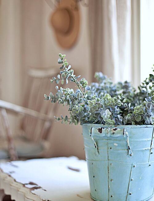 Pale blue French bucket filled with flowers