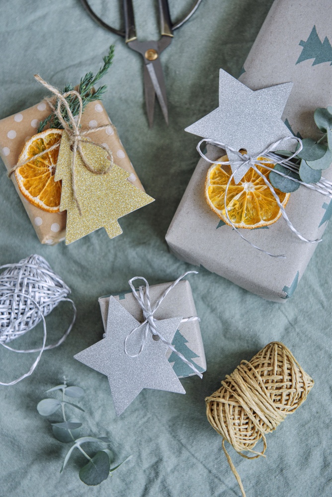 Christmas presents with kraft paper, string, and dried orange slices