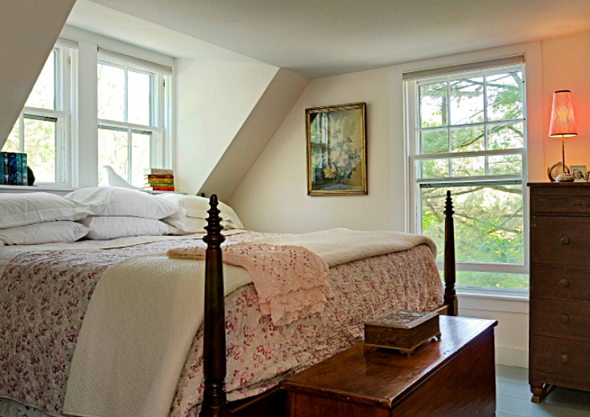Antique bed in under-the-eaves bedroom