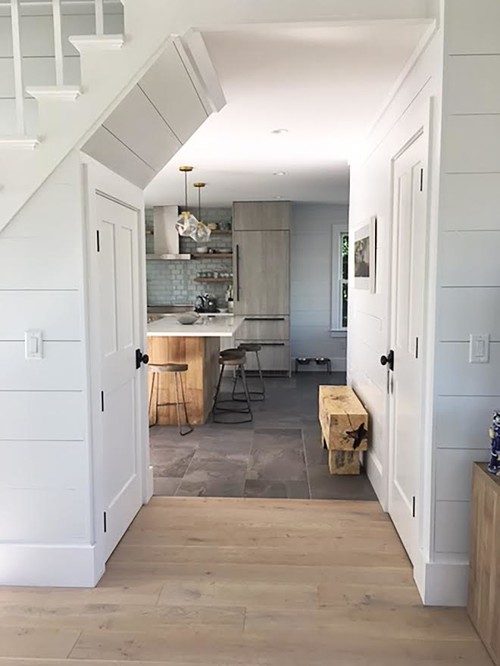 White painted staircase with shiplap walls