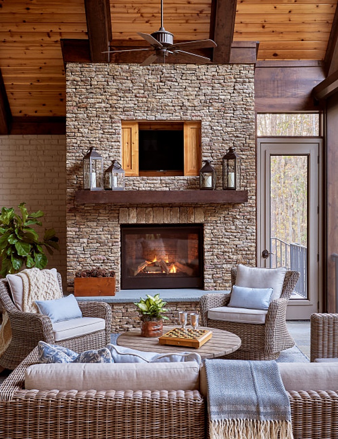 Custom outdoor stone fireplace with enclosed television