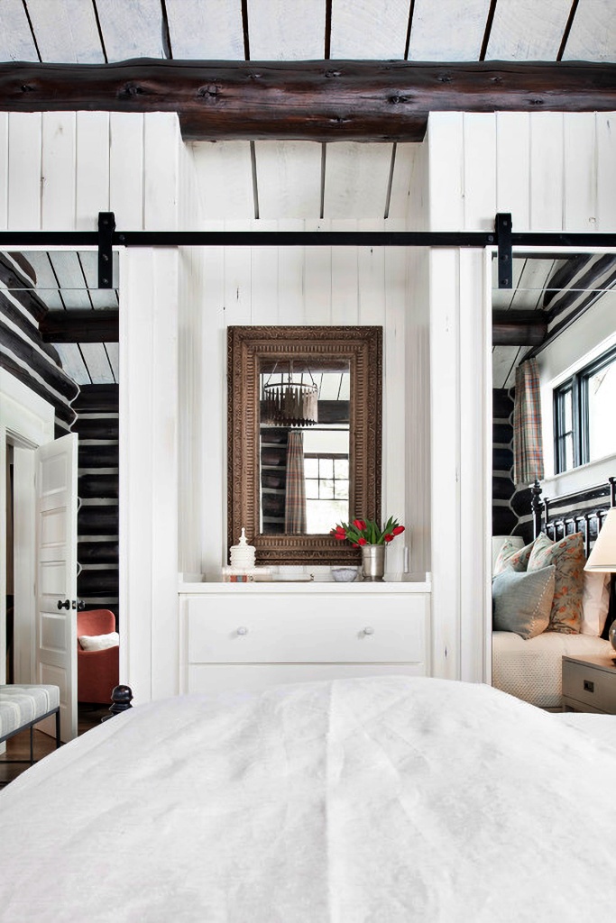 mirrored sliding barn doors in cabin bedroom